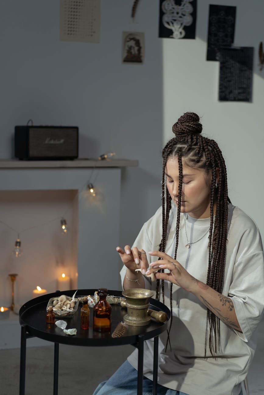 woman in white long sleeve shirt holding clear glass cup