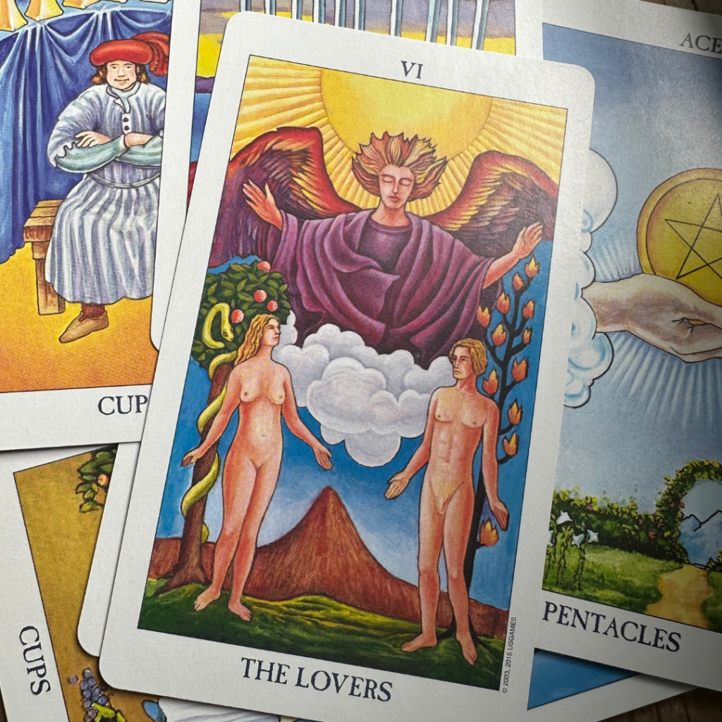 The Lovers tarot card from Roder-Waite-Smith tarot deck on a pile of random tarot cards
