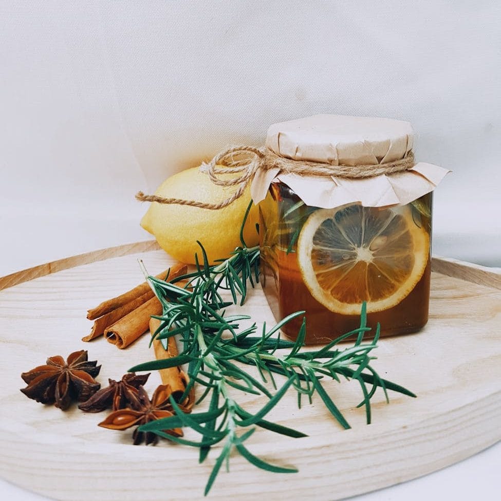 photo of jar near cinnamon sticks