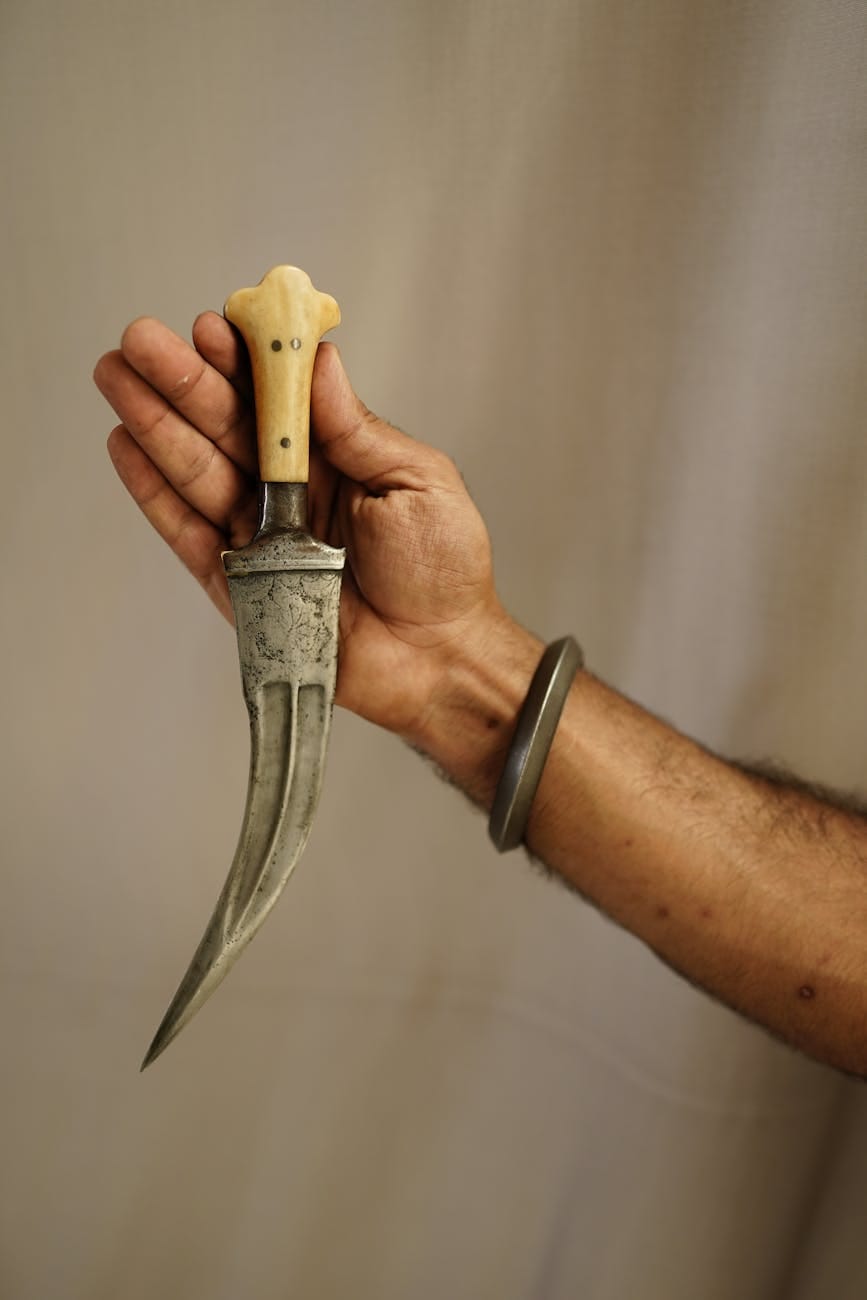 a person holding sharp pointed knife